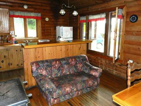 View of the open concept area featuring the kitchen and living room of Le Montagnard cottage.