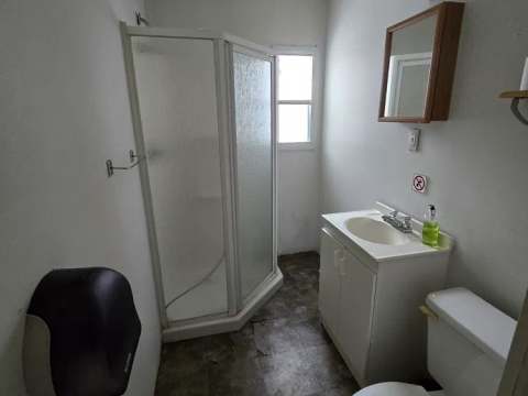 This bathroom is equipped with a shower, a sink, and a toilet.
