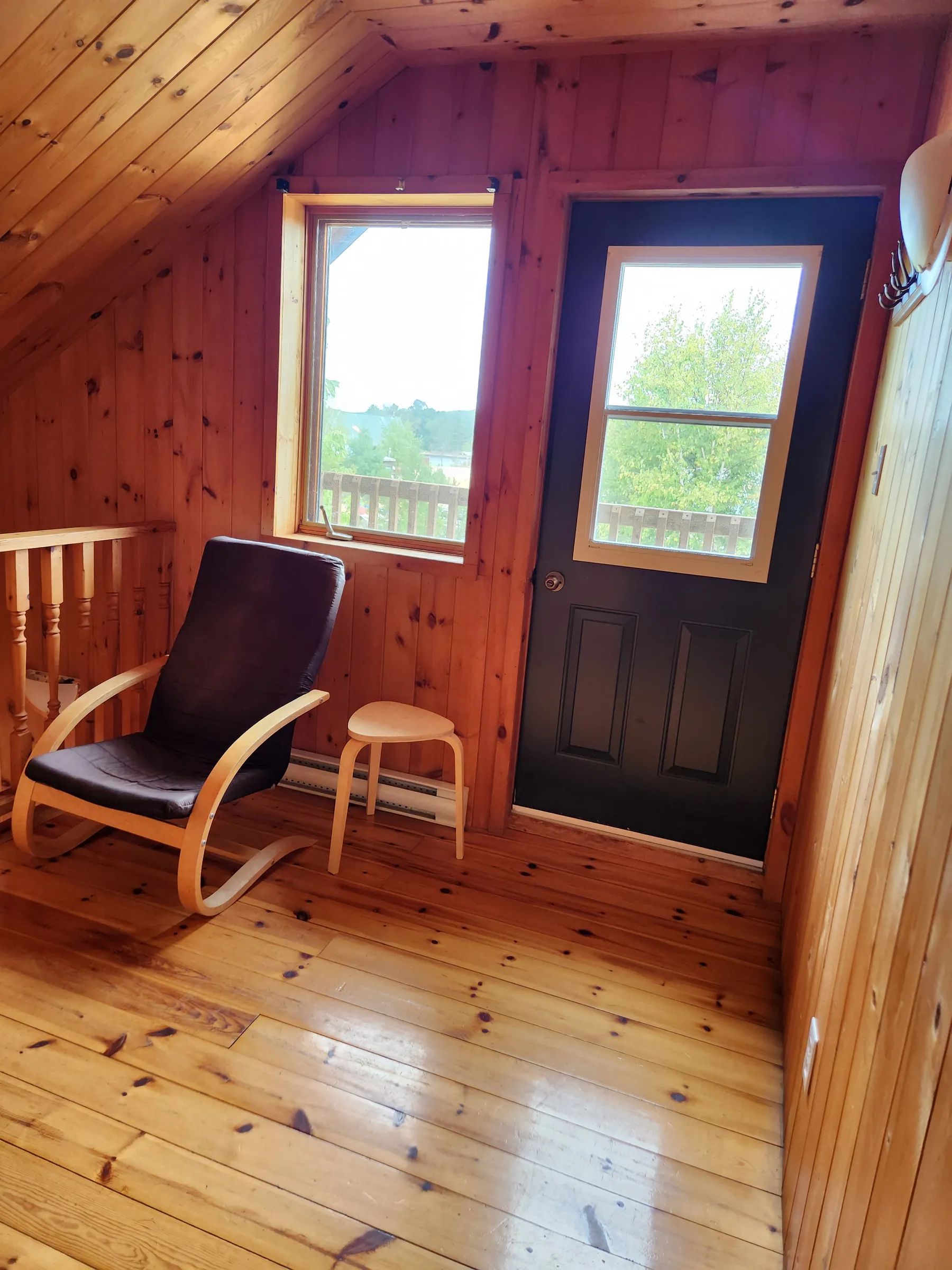 Interior view of a seating area near the door and window in the cabin.