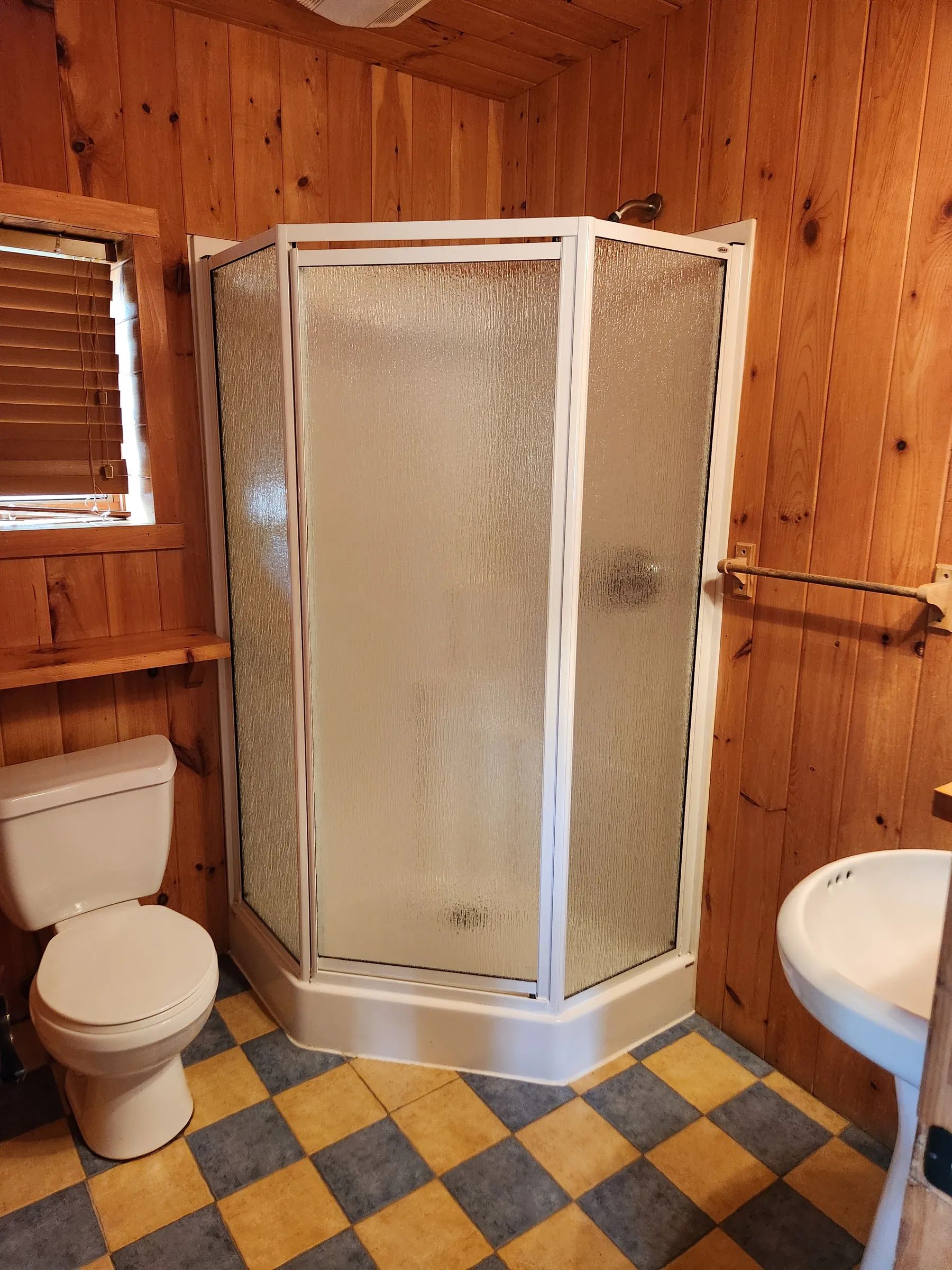 The cottage bathroom includes a shower, a toilet, and a sink.