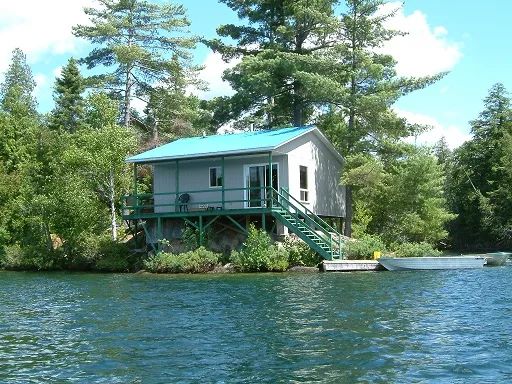 Cottage 19 is located by the lake, featuring a deck and direct access to the dock.