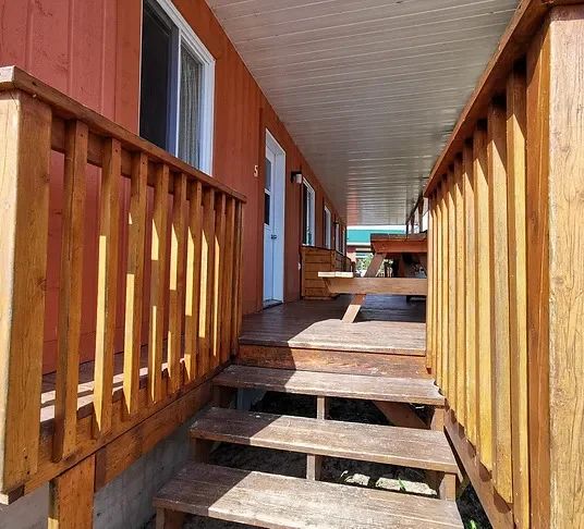 The covered veranda of cabin number 5 offers an outdoor space to enjoy nature.