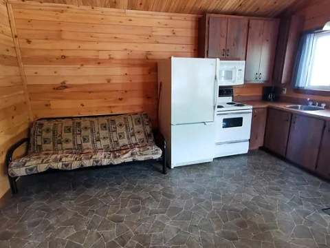 This open-concept kitchen includes a sofa and the appliances needed for your stay.