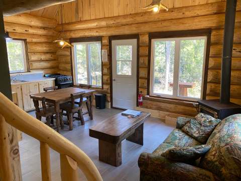 Overview of the open area including the kitchen, dining room, and living room of the cabin.