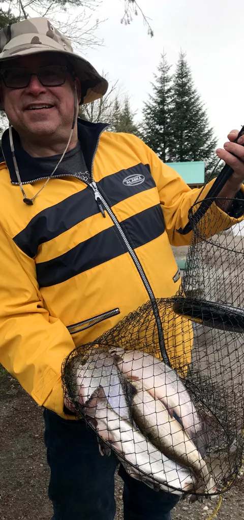 Satisfied angler with a brook trout catch at Club Rossignol at Pourvoirie Club Rossignol, Laurentides, Quebec