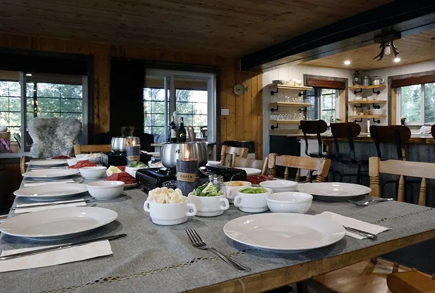 A table set for a meal in the lodge's warm dining room.