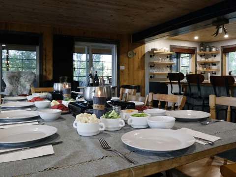 A table set for a meal in the lodge's warm dining room.