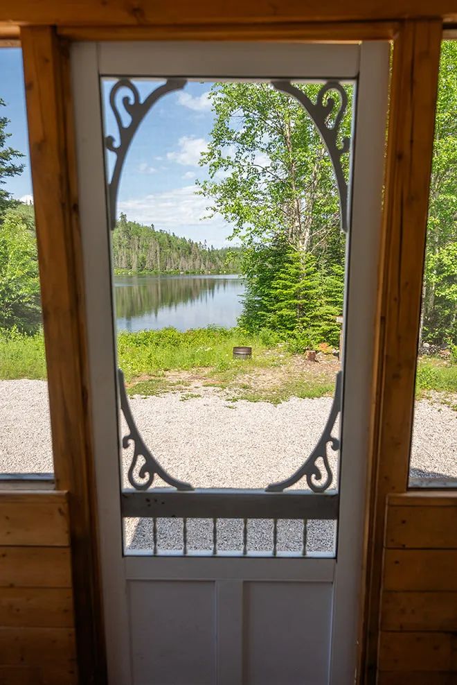 View of the lake from the cottage porch screen door.