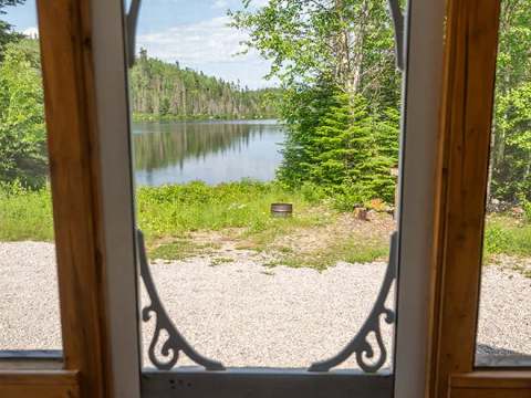 View of the lake from the cottage porch screen door.