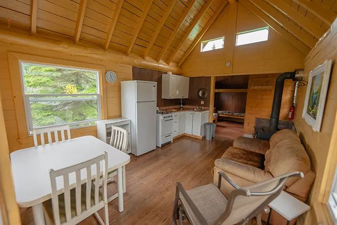 Overview of the main living area in the cottage, including the kitchen, dining room, and living room.