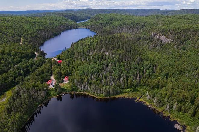 Aerial view of our cabins located in the forest near the lakes.