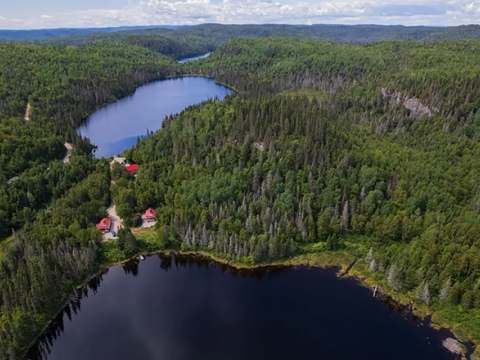 Aerial view of our cabins located in the forest near the lakes.