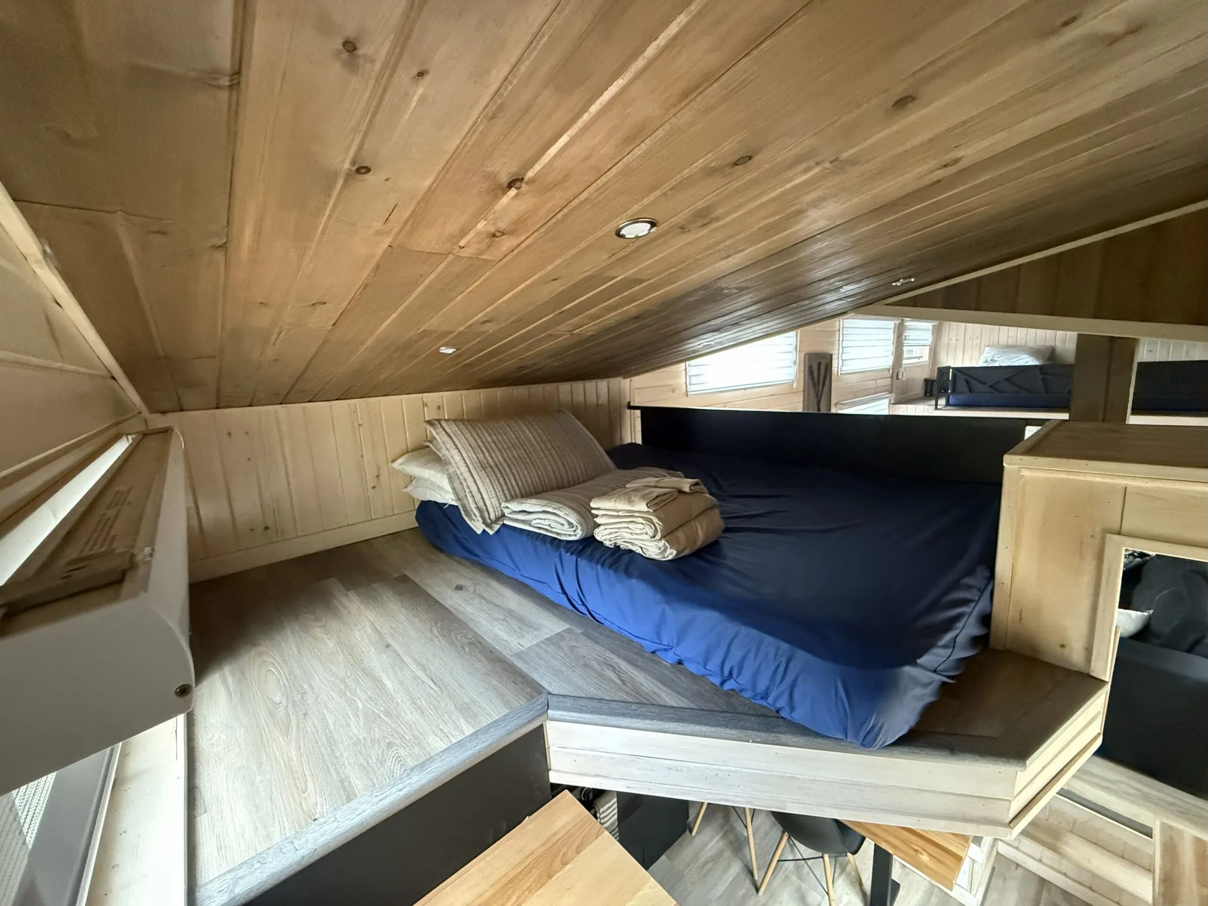 The mezzanine area featuring a double bed in the tiny house.
