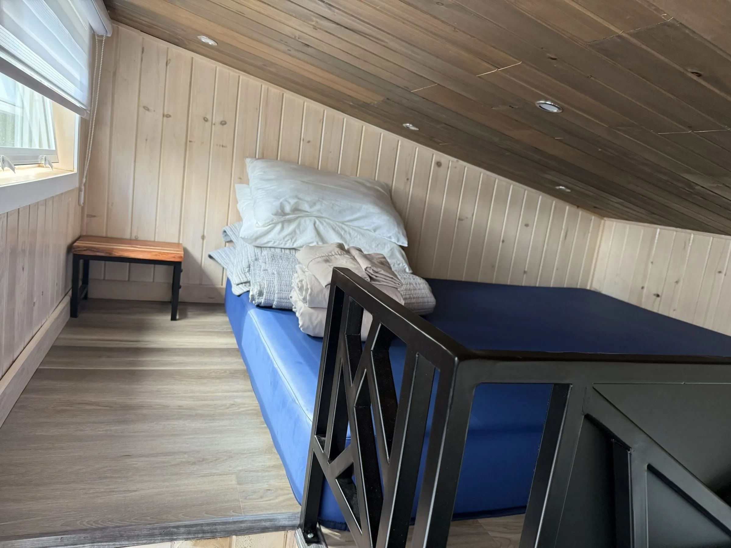 View of the mezzanine with mattress and bedding in cabin 11.