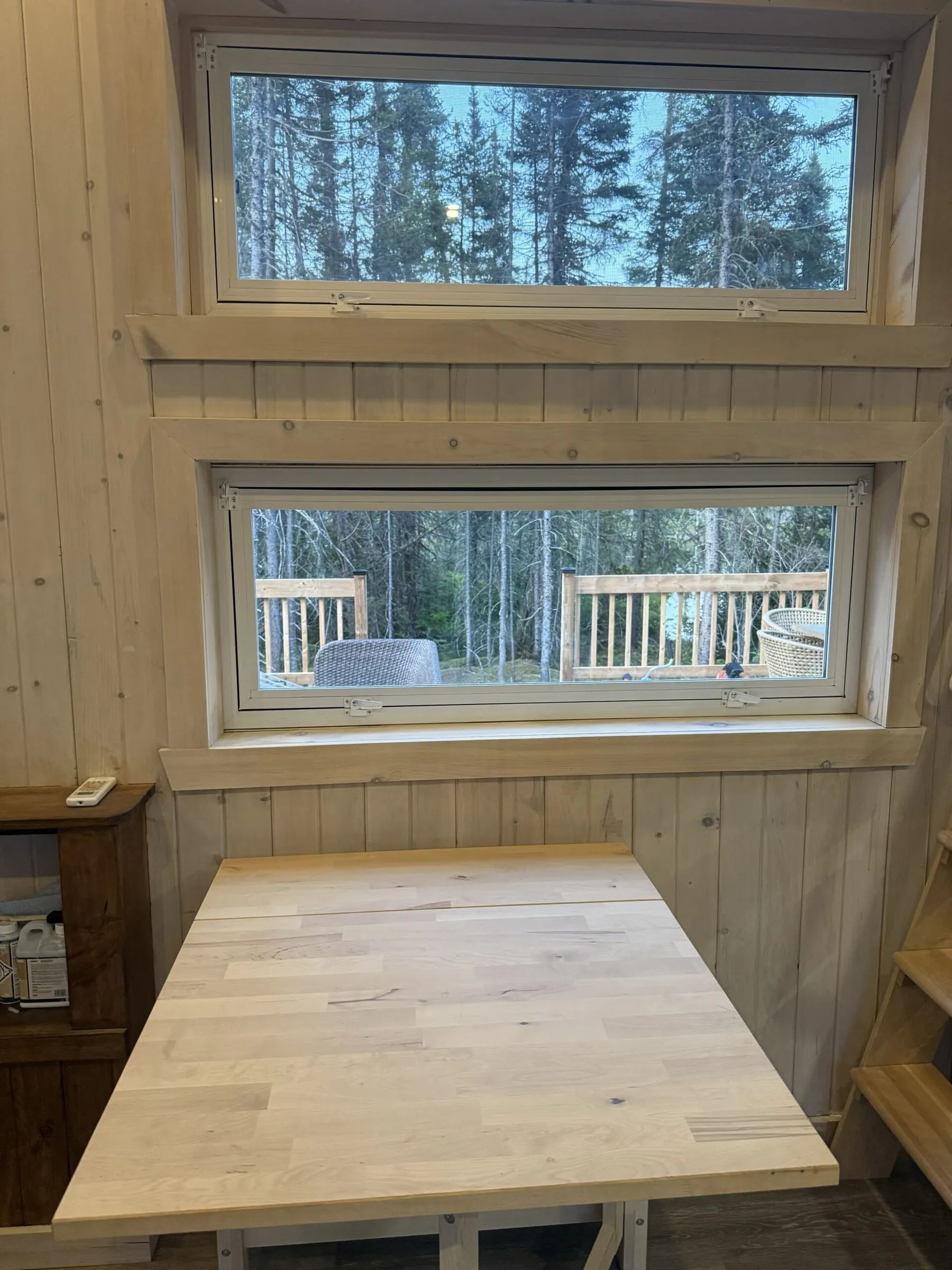View of the forest from the wooden table inside cabin 8.