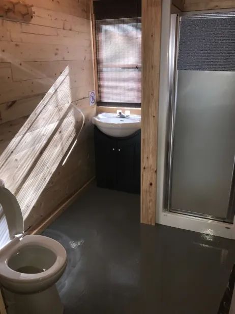 La salle de bain du chalet comprend une douche, un lavabo et une toilette.