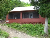 Exterior view of chalet 1A with its screened-in porch.