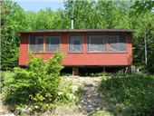Exterior view of cabin 1A located in the forest.