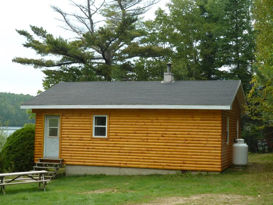 Side view of cabin 3 located in a wooded setting near the lake.