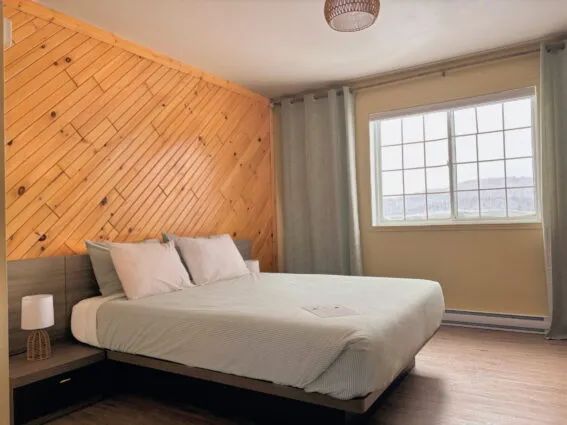A comfortable bedroom with a double bed at the Domaine Bazinet inn.