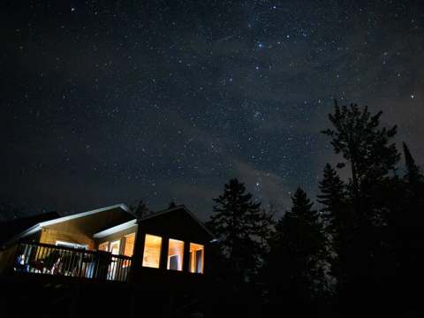 The Faucon cottage under a starry sky during a quiet evening.