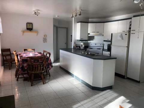 The equipped kitchen and dining area of the La Martre cottage.