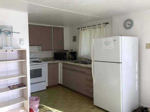 The cottage's equipped kitchen includes a stove and refrigerator for your meals.