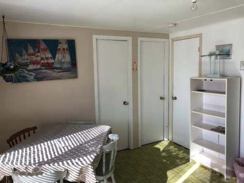 View of the dining area in the Geai Bleu cottage with its interior doors and shelving.