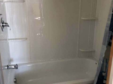 The cottage bathroom features a bathtub with an integrated shower.