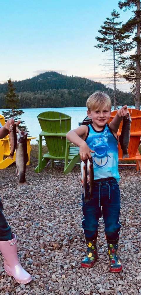 Angler showing off a catch of brook trout. at Pourvoirie du Club Bataram, Charlevoix, Quebec
