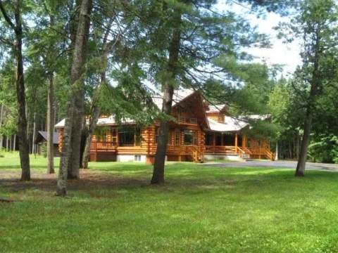 Exterior view of the family cottage surrounded by mature trees and greenery.