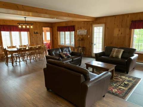 Open living area featuring a comfortable lounge space and an adjoining dining room.