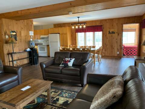 The open-concept living and dining area provides a cozy and fully equipped living space.