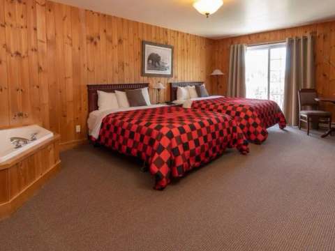 This superior room features two queen beds, a jetted tub, and a dining area.