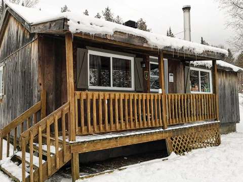 Chalet number 10 is surrounded by snow in the winter season.