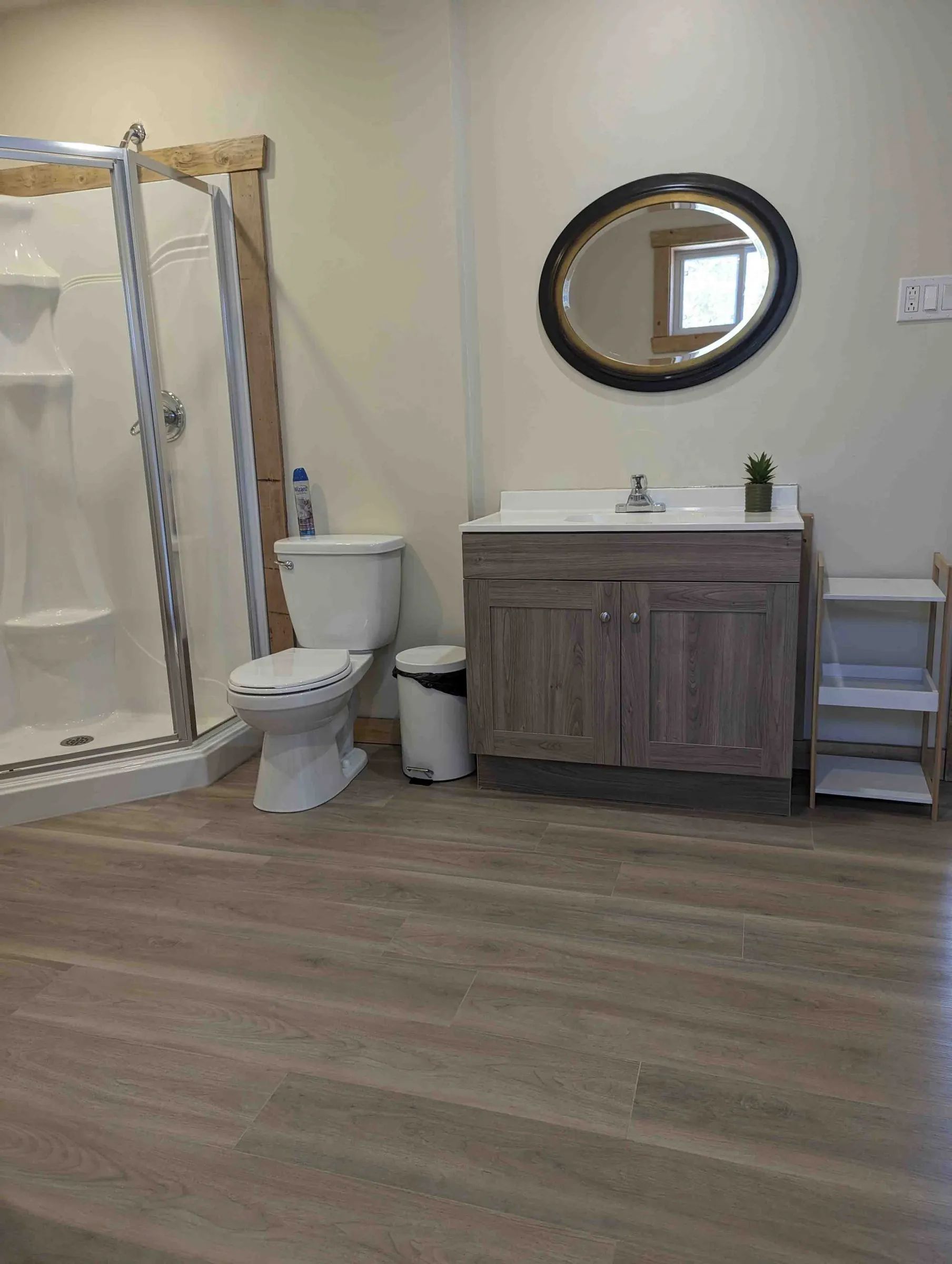The cottage bathroom includes a shower, a toilet, and a modern vanity.