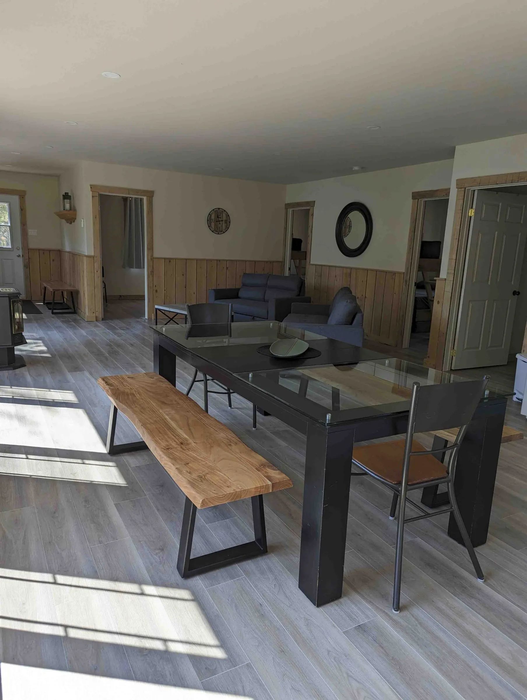 The open area of the Canard cottage includes a dining table and a seating area.