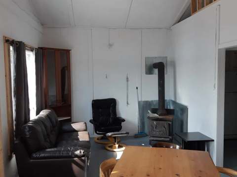 The chalet living and dining area with a wood stove and comfortable furniture.