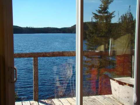 View of the lake and forest from the patio door of the South Pavilion.