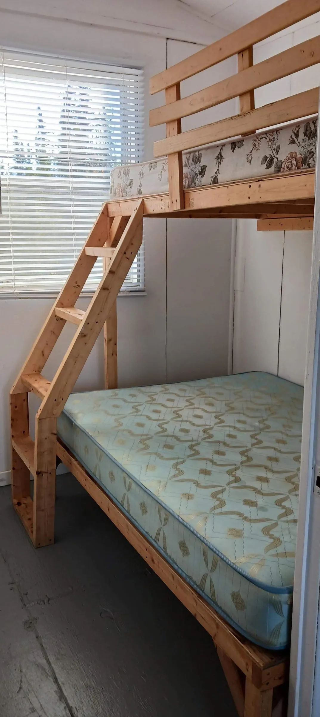 A wooden bunk bed is installed in one of the cabin's bedrooms.