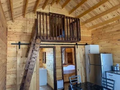 View of the chalet interior with its mezzanine and closed bedrooms.