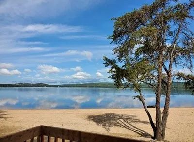 View of the beach and the lake from the balcony of one of the cabins.