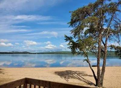 View of the beach and the lake from the balcony of one of the cabins.
