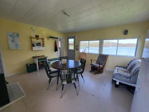 The living area of the Sorbier cabin includes a dining table and a view of the lake.