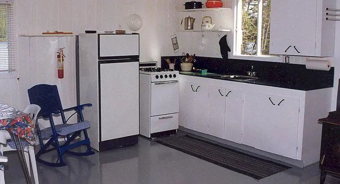 The chalet's functional kitchen includes a stove, a refrigerator, and storage space.