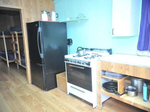 The equipped kitchen is adjacent to the cottage's sleeping area.