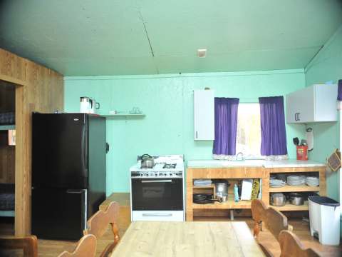 The equipped kitchen and dining area of Le Vétéran cabin.