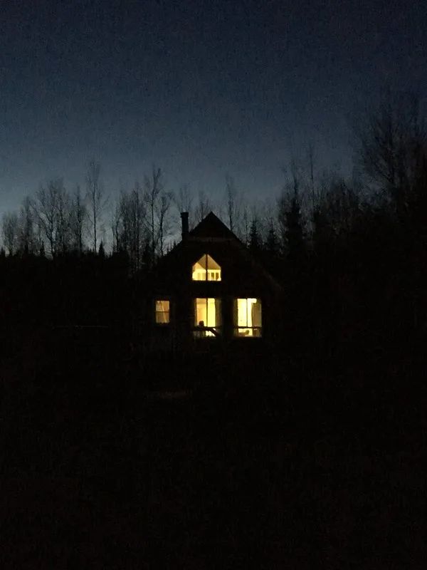 The Hibou cabin is illuminated at nightfall.