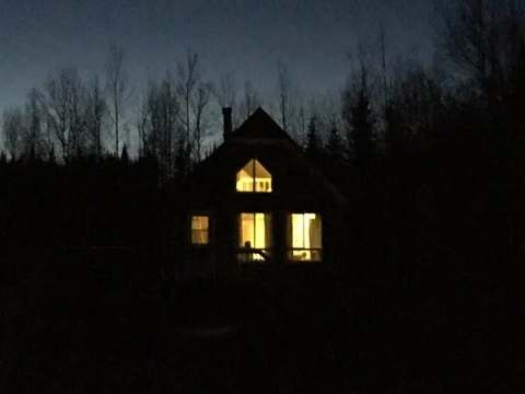 The Hibou cabin is illuminated at nightfall.