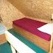 A single bed located in the attic section of Le Harfang cabin.